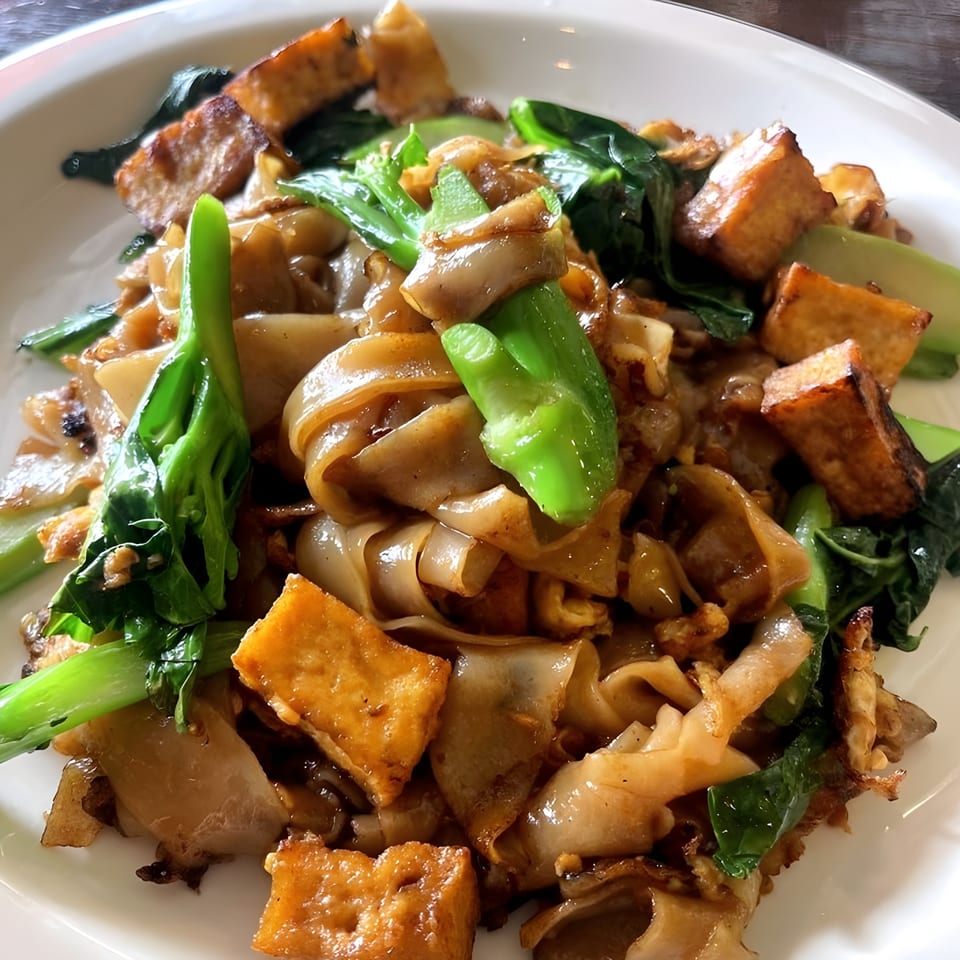 Close-up of Boran Thai Restaurant's Pad See Ew with wide noodles, tofu, and Chinese broccoli.